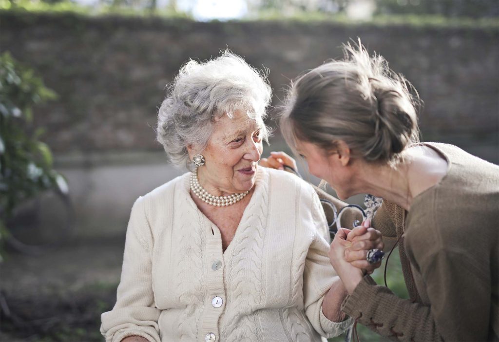 young lady helping an old resident