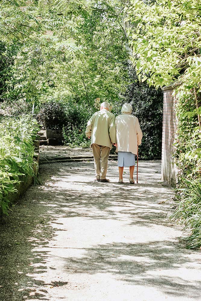 2 residents walking in the garden