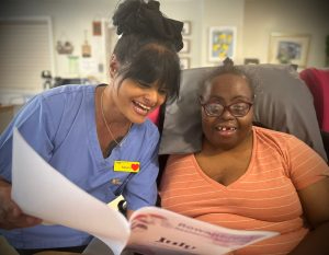 carer and resident reading