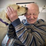 Dog licking mans face