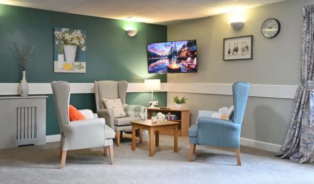 armchairs in a lounge with green walls