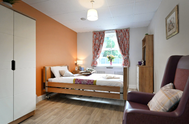 Bedroom with orange wall and armchair