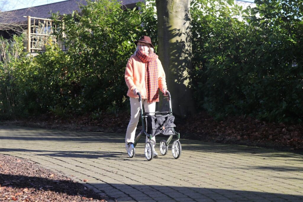 woman walking outside using a walking aid