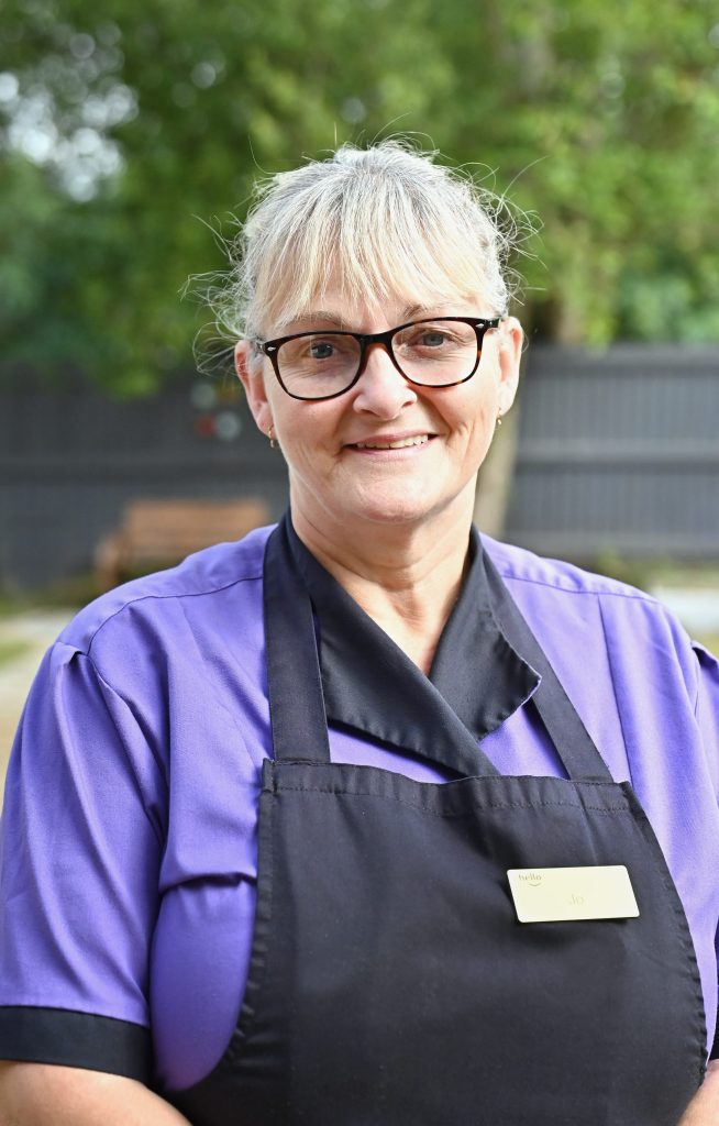 woman with blonde hair in an apron