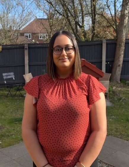 woman in red top smiling outdoors