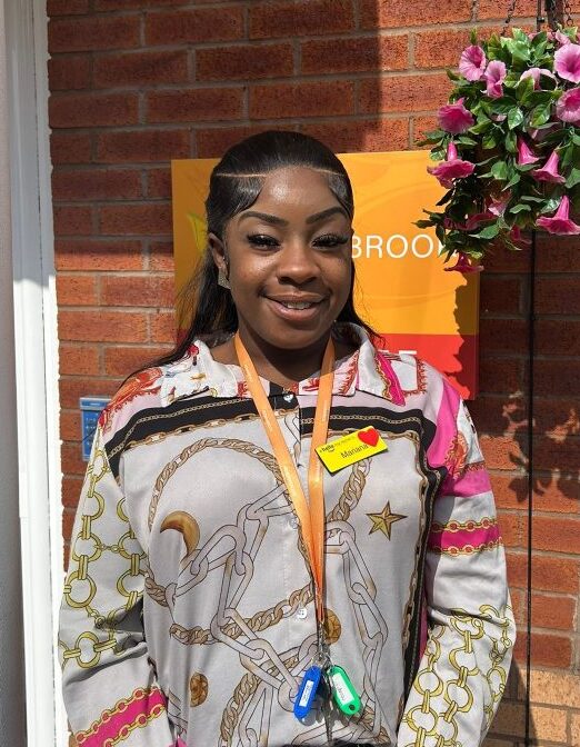 female staff member smiling outside care home